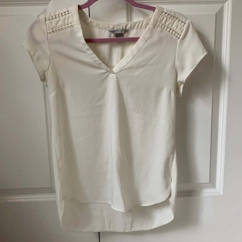 Cream-colored v-neck blouse